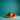 Colorful striped wood and red rope toy on an orange stand against a teal background