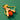 Wooden slingshot with an orange ball on a green background