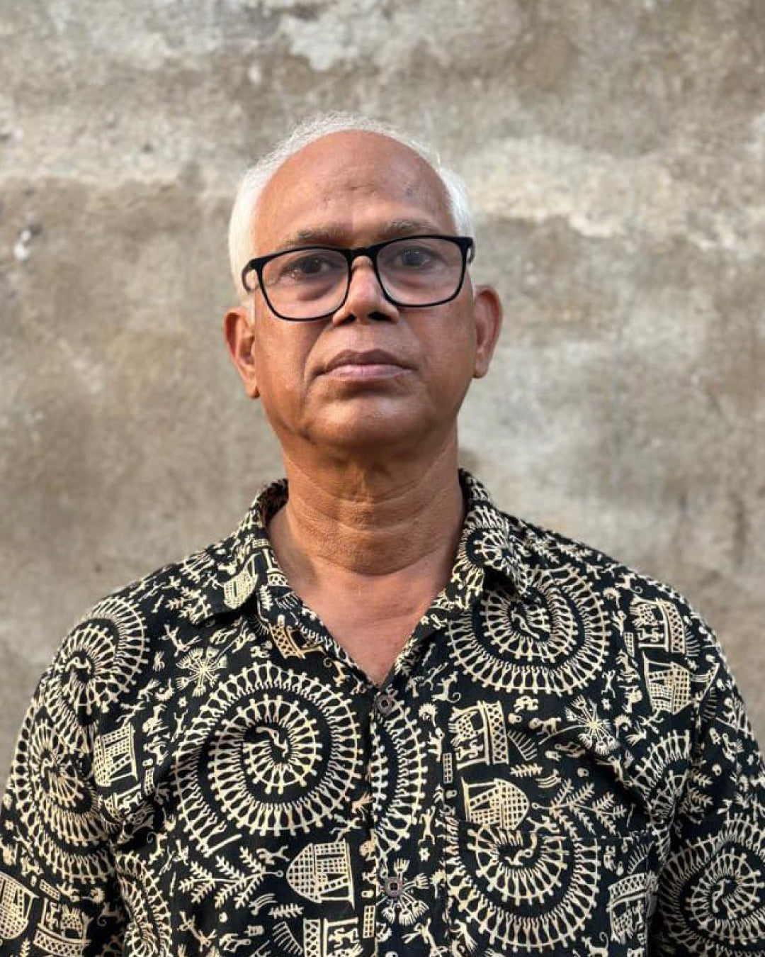 Portrait of one of Kala Curry’s artist partners against a weathered wall
